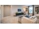 Bright living room with a sofa, a black console, a TV, and a coffee table at 2038 Brookhill Way Lot 6, Snellville, GA 30078