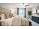 Inviting main bedroom with elegant decor, tufted headboard, ceiling fan, and ample natural light at 2038 Brookhill Way Lot 6, Snellville, GA 30078