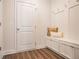 Mudroom area with a bench, storage cabinets, hooks, and wood-look flooring at 2038 Brookhill Way Lot 6, Snellville, GA 30078