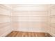 Empty walk-in closet with white wire shelving and wood-look flooring, ready for personalization at 2038 Brookhill Way Lot 6, Snellville, GA 30078