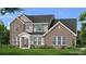 Charming two-story brick home with a beautifully landscaped front yard and covered entryway at 301 Moab Ct, Stockbridge, GA 30281