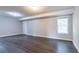 Finished basement with durable wood flooring and natural light from a window at 962 Taylors Farm Ct, Canton, GA 30115