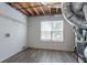 Unfinished basement space with utilities, wood floors, and exposed rafters at 962 Taylors Farm Ct, Canton, GA 30115