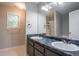 Bathroom featuring double sink vanity and a large mirror and a window at 962 Taylors Farm Ct, Canton, GA 30115