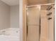 Bathroom features a soaking tub and shower with glass door at 962 Taylors Farm Ct, Canton, GA 30115