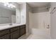 Bathroom featuring a vanity with dark cabinets and a shower-tub combo at 962 Taylors Farm Ct, Canton, GA 30115