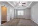Bedroom features neutral walls, soft carpet, a ceiling fan, and a tray ceiling at 962 Taylors Farm Ct, Canton, GA 30115