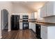 Bright kitchen with white cabinets, black appliances and hardwood floors at 962 Taylors Farm Ct, Canton, GA 30115