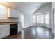 Kitchen area with white cabinets, black dishwasher, and bright breakfast nook at 962 Taylors Farm Ct, Canton, GA 30115