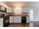 Bright kitchen with white cabinets, black appliances and laminate countertops at 962 Taylors Farm Ct, Canton, GA 30115