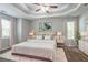 Stylishly decorated bedroom features a tray ceiling, soft carpet, and two large windows at 962 Taylors Farm Ct, Canton, GA 30115