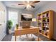 Bright office space featuring a ceiling fan, light wood desk, and modern bookcase at 962 Taylors Farm Ct, Canton, GA 30115