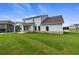Spacious backyard with a covered patio, ample windows, brick foundation, and green grass at 316 Moab Ct, Stockbridge, GA 30281