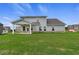 Spacious backyard with a covered patio, ample windows, and brick foundation at 316 Moab Ct, Stockbridge, GA 30281