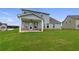 Spacious backyard with a covered patio, ample windows, and brick foundation at 316 Moab Ct, Stockbridge, GA 30281