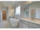 Bright bathroom featuring a standalone tub, double sinks, and a large window at 316 Moab Ct, Stockbridge, GA 30281