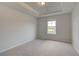 This bedroom features neutral walls, carpet, and a window to let in natural light at 316 Moab Ct, Stockbridge, GA 30281