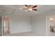 Large bedroom with coffered ceilings, ceiling fan, and carpet at 316 Moab Ct, Stockbridge, GA 30281