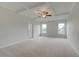 Spacious bedroom with carpet, tray ceiling, ceiling fan, and natural light at 316 Moab Ct, Stockbridge, GA 30281