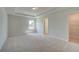 This bedroom features neutral walls, carpet, a window, and a door to a closet at 316 Moab Ct, Stockbridge, GA 30281