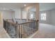 This hallway features an ornate staircase and a view into a room with natural light at 316 Moab Ct, Stockbridge, GA 30281
