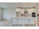 Bright kitchen featuring a central island, stylish pendant lights, and modern fixtures at 316 Moab Ct, Stockbridge, GA 30281