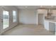 A living room adjacent to the kitchen with bright windows and a door to the outside at 316 Moab Ct, Stockbridge, GA 30281