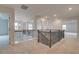 Upstairs loft with decorative railing, ample natural light, and carpet at 316 Moab Ct, Stockbridge, GA 30281