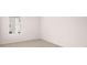 Bright bedroom with large window, neutral carpet, and fresh white walls at 360 Sound Cir, Stockbridge, GA 30281