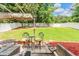 Large, fenced backyard featuring a patio with outdoor seating and a large grassy lawn at 6317 Selborn Sw Dr, Atlanta, GA 30331
