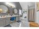 Stylish bathroom featuring double vanity, elegant mirrors, and a tub-shower combination at 6317 Selborn Sw Dr, Atlanta, GA 30331