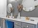 Elegant bathroom featuring double sinks, sleek gray cabinetry, and gold fixtures at 6317 Selborn Sw Dr, Atlanta, GA 30331