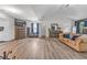 Bright, open primary bedroom featuring vaulted ceilings, wood-look floors, and comfortable seating area at 6317 Selborn Sw Dr, Atlanta, GA 30331