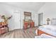 Bedroom featuring a vanity, two doors, neutral paint color, and light hardwood floors at 6317 Selborn Sw Dr, Atlanta, GA 30331