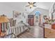 Bright bedroom featuring a ceiling fan, vaulted ceiling, hardwood floors, and decorative furnishings at 6317 Selborn Sw Dr, Atlanta, GA 30331