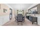 Elegant dining room with a sophisticated chandelier, stylish furniture, and ample natural light at 6317 Selborn Sw Dr, Atlanta, GA 30331