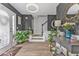 Bright foyer with wood flooring, staircase, decorative mirror, and stylish console table with plants and decor at 6317 Selborn Sw Dr, Atlanta, GA 30331