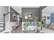Inviting home foyer featuring decorative mirror, wooden floors, console table, and a staircase leading upstairs at 6317 Selborn Sw Dr, Atlanta, GA 30331