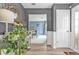 Elegant foyer with a view into the living room, featuring modern decor, wood floors, and neutral color palette at 6317 Selborn Sw Dr, Atlanta, GA 30331