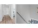Hallway leading to bedroom, natural light, and modern handrails on the staircase at 6317 Selborn Sw Dr, Atlanta, GA 30331