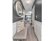 Hallway with wood floors, bench, and decorative wall mirror leading to a kitchen and dining area at 6317 Selborn Sw Dr, Atlanta, GA 30331