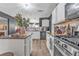 Open kitchen with granite countertops, stainless steel appliances, and a view into the living room at 6317 Selborn Sw Dr, Atlanta, GA 30331