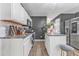 Modern kitchen with white cabinets, granite countertops, stainless steel appliances, and an island at 6317 Selborn Sw Dr, Atlanta, GA 30331