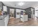 Open concept kitchen features white cabinets, stainless appliances, granite counters, and a central island at 6317 Selborn Sw Dr, Atlanta, GA 30331