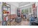 Bright living room with a brown sofa, a large window, and hardwood floors at 6317 Selborn Sw Dr, Atlanta, GA 30331