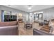 Open-concept living room with fireplace and view into the modern eat-in kitchen at 6317 Selborn Sw Dr, Atlanta, GA 30331