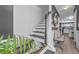Well-lit staircase with modern finishes and a bench near a view of the kitchen at 6317 Selborn Sw Dr, Atlanta, GA 30331