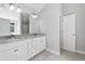 Bathroom featuring double sinks with granite countertop, tile floors, and white cabinets at 2565 Aaron Ct, Loganville, GA 30052