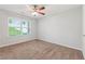Bedroom featuring neutral walls, carpeted floors, a ceiling fan, and a window with natural light at 2565 Aaron Ct, Loganville, GA 30052