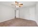 Bedroom with neutral walls, carpeted floors, ceiling fan and two doors to closet and bedroom at 2565 Aaron Ct, Loganville, GA 30052